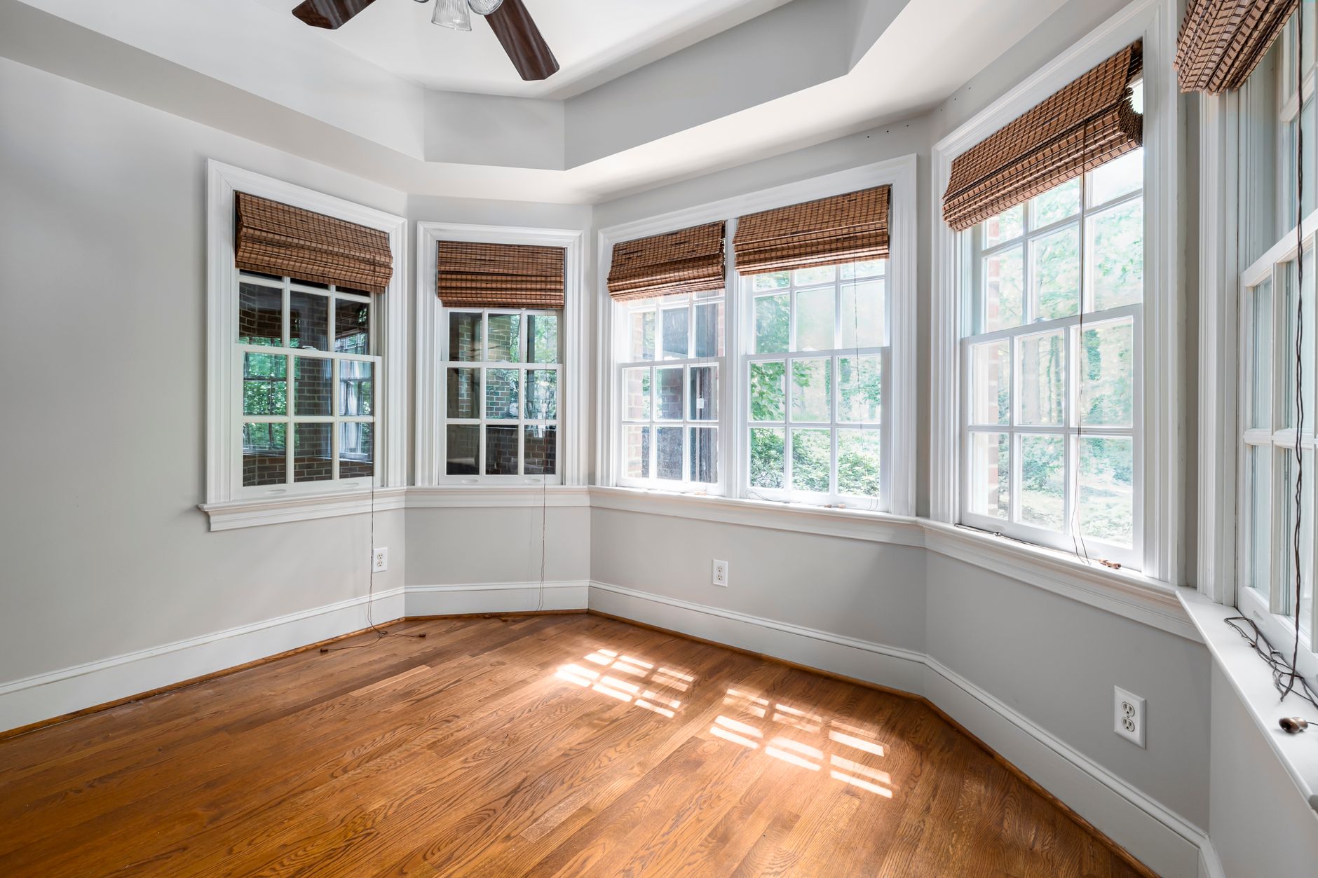 Spacious room with bay windows and a wooden floor